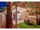 Cozy backyard with covered patio, beautiful tropical landscaping, and an upper-level patio at 101 Morning Dr, Henderson, NV 89012