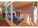 Charming backyard with a covered patio, custom rock feature, and tropical plants at 101 Morning Dr, Henderson, NV 89012