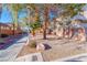 View of meticulously maintained community grounds with sidewalk and mature trees at 101 Morning Dr, Henderson, NV 89012