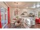 Dining area with stylish chandelier, table for four, and kitchen access at 101 Morning Dr, Henderson, NV 89012