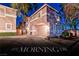 Charming two-story home with a two-car garage and landscaped front yard at dusk at 101 Morning Dr, Henderson, NV 89012