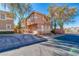 Well-maintained two-story home with a stucco exterior, large driveway and mature landscaping at 101 Morning Dr, Henderson, NV 89012