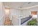 Open hallway features a decorative chandelier, natural lighting, and view of house plants at 101 Morning Dr, Henderson, NV 89012