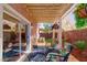 Charming covered patio featuring comfortable seating and a beautifully landscaped backyard at 101 Morning Dr, Henderson, NV 89012