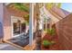 Comfortable covered patio with outdoor seating, complemented by tropical landscaping at 101 Morning Dr, Henderson, NV 89012