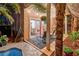 Inviting backyard patio with lounge chairs, pergola, and views to the house through glass sliding doors at 101 Morning Dr, Henderson, NV 89012