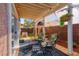 Inviting covered patio area with outdoor seating and lush hanging floral arrangements at 101 Morning Dr, Henderson, NV 89012