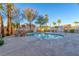 Community swimming pool surrounded by lush trees, beautiful landscaping, and decorative lighting at 101 Morning Dr, Henderson, NV 89012
