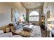 Spacious living room featuring a large arched window, plush seating, and stylish decor at 10210 Juniper Creek Ln, Las Vegas, NV 89145