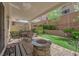 Relax in this outdoor oasis, complete with a putting green, a covered patio, and a cozy firepit area at 10457 Raining Sky St, Las Vegas, NV 89178