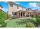 This backyard boasts a well-manicured putting green, patio, and lush greenery, creating an inviting outdoor space at 10457 Raining Sky St, Las Vegas, NV 89178