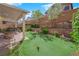 The backyard features a putting green, a covered patio, and a stone firepit, perfect for outdoor entertainment at 10457 Raining Sky St, Las Vegas, NV 89178