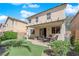 Backyard with covered patio, seating, manicured lawn, and putting green at 10457 Raining Sky St, Las Vegas, NV 89178