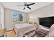 Bedroom with ceiling fan, TV and a window at 10457 Raining Sky St, Las Vegas, NV 89178