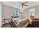 Bedroom featuring a ceiling fan and large window at 10457 Raining Sky St, Las Vegas, NV 89178