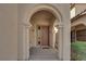 The entryway features a charming arched entrance and a well-lit porch, creating a welcoming first impression at 10457 Raining Sky St, Las Vegas, NV 89178