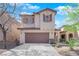 Lovely two-story home with a two-car garage, a well-maintained lawn, and mature trees, creating a cozy atmosphere at 10457 Raining Sky St, Las Vegas, NV 89178