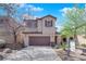Beautiful two-story home with a two-car garage, a well-kept lawn, and mature trees, offering comfortable living at 10457 Raining Sky St, Las Vegas, NV 89178