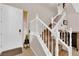 Inviting foyer with a staircase, wood railing, and a white front door at 10457 Raining Sky St, Las Vegas, NV 89178