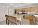 Kitchen with granite countertops, stainless steel appliances, and a breakfast bar island at 10457 Raining Sky St, Las Vegas, NV 89178