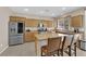 Bright kitchen with granite countertops, stainless steel appliances, and an island with seating at 10457 Raining Sky St, Las Vegas, NV 89178