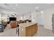 Open-concept space features a kitchen island, a cozy living room, and a staircase to the upper level at 10457 Raining Sky St, Las Vegas, NV 89178