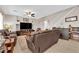 Comfortable living room with a fireplace, TV, and staircase in the background at 10457 Raining Sky St, Las Vegas, NV 89178