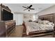 Comfortable main bedroom with wood floors, a ceiling fan, and ample space at 10457 Raining Sky St, Las Vegas, NV 89178