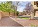 Landscaped backyard with low maintenance rock, small pavers, artificial turf, and mature trees at 1053 Hickory Park St, Las Vegas, NV 89138