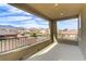 An open, covered balcony overlooks neighborhood homes and beautiful mountain views at 1053 Hickory Park St, Las Vegas, NV 89138