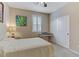 Well-lit bedroom featuring a bed, piano, and a large window for natural light at 1053 Hickory Park St, Las Vegas, NV 89138