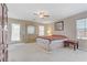 Spacious bedroom featuring neutral carpet, ceiling fan, and furniture at 1053 Hickory Park St, Las Vegas, NV 89138