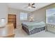 Well-lit bedroom featuring a desk, shelving unit, and comfortable bed, perfect for relaxation and productivity at 1053 Hickory Park St, Las Vegas, NV 89138