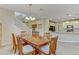 Open-concept dining area connecting to the kitchen, featuring stairs, neutral decor, and ample space at 1053 Hickory Park St, Las Vegas, NV 89138