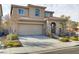 Charming two-story home featuring a tile roof, neutral stucco, stone accents, and a two-car garage at 1053 Hickory Park St, Las Vegas, NV 89138
