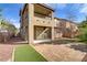 Two story home with desert landscaping, brick pavers, and small section of artificial turf at 1053 Hickory Park St, Las Vegas, NV 89138