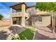 Two story home featuring neutral stucco, brick pavers, desert landscaping and covered porch at 1053 Hickory Park St, Las Vegas, NV 89138