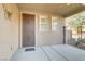 Welcoming front porch with decorative security door, small windows, and elegant butterfly wall decor at 1053 Hickory Park St, Las Vegas, NV 89138