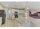 Spacious kitchen with light cabinets, granite countertops, a center island, and stainless steel appliances at 1053 Hickory Park St, Las Vegas, NV 89138