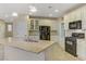 Modern kitchen features a large island, stainless steel appliances, and decorative backsplash at 1053 Hickory Park St, Las Vegas, NV 89138