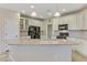 Bright kitchen featuring white cabinets, granite countertops, a center island, and tile backsplash at 1053 Hickory Park St, Las Vegas, NV 89138