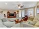 Comfortable living room featuring plush seating, ceiling fan, and bright natural light at 1053 Hickory Park St, Las Vegas, NV 89138
