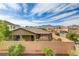 A single story home with a tan privacy fence with mountains in the background at 1053 Hickory Park St, Las Vegas, NV 89138
