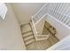 Carpeted staircase with white railings connects the upper and lower levels of this home at 1053 Hickory Park St, Las Vegas, NV 89138