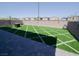 Backyard featuring an artificial turf yard, brick walls, and a paved patio area at 1122 Brilliant Meadow Ave, North Las Vegas, NV 89086