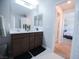 Bright bathroom featuring a double vanity, modern fixtures, and a view of the bedroom at 1122 Brilliant Meadow Ave, North Las Vegas, NV 89086