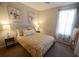 Cozy bedroom with neutral tones, large window, carpet flooring, and decorative artwork at 1122 Brilliant Meadow Ave, North Las Vegas, NV 89086