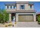 Two-story home with a two-car garage, desert landscaping, and a neutral-toned facade at 1122 Brilliant Meadow Ave, North Las Vegas, NV 89086