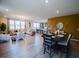 Open-concept living and dining area with hardwood floors, neutral decor, and ample natural light at 1122 Brilliant Meadow Ave, North Las Vegas, NV 89086