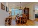 Charming dining room with wood table, chandelier, and built-in hutch at 11477 Timber Mountain Ave, Las Vegas, NV 89135